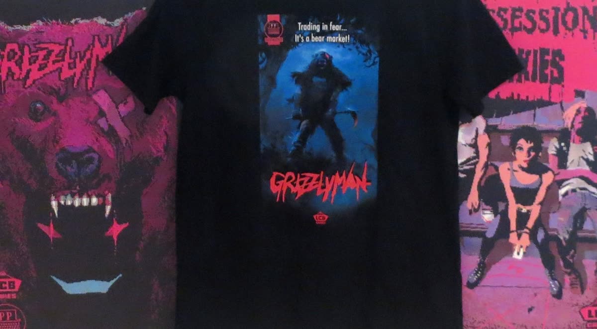 Black Grizzlyman tee in front of the Grizzlyman and Possession Junkies posters